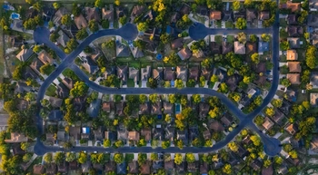 Aerial shot of suburban neighborhood in Edinburg, Texas, highlighting roads and houses.