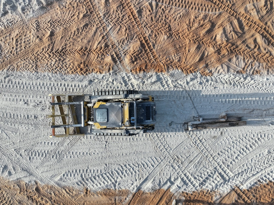 John Deere 333G preparing roadbed surface