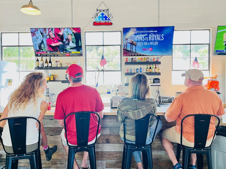 Blanco Feed Store patrons watching sports at the bar
