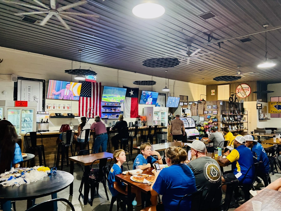 Kids and parents watching sports at the Blanco Feed Store