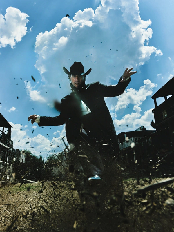 A silhouetted figure leaping in the air surrounded by a cloudy sky, conveying a sense of motion and dynamic energy.