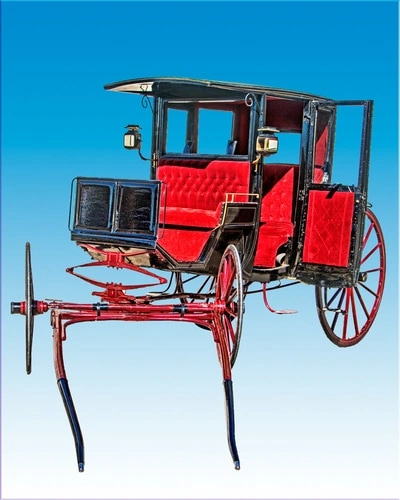 A vintage, red horse-drawn carriage or coach against a bright blue sky. The carriage has a covered passenger area and ornate details.