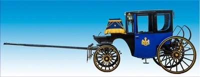 A vintage blue carriage with yellow trim and a decorative design, pulled by horses and representing a classic mode of transportation from a bygone era.