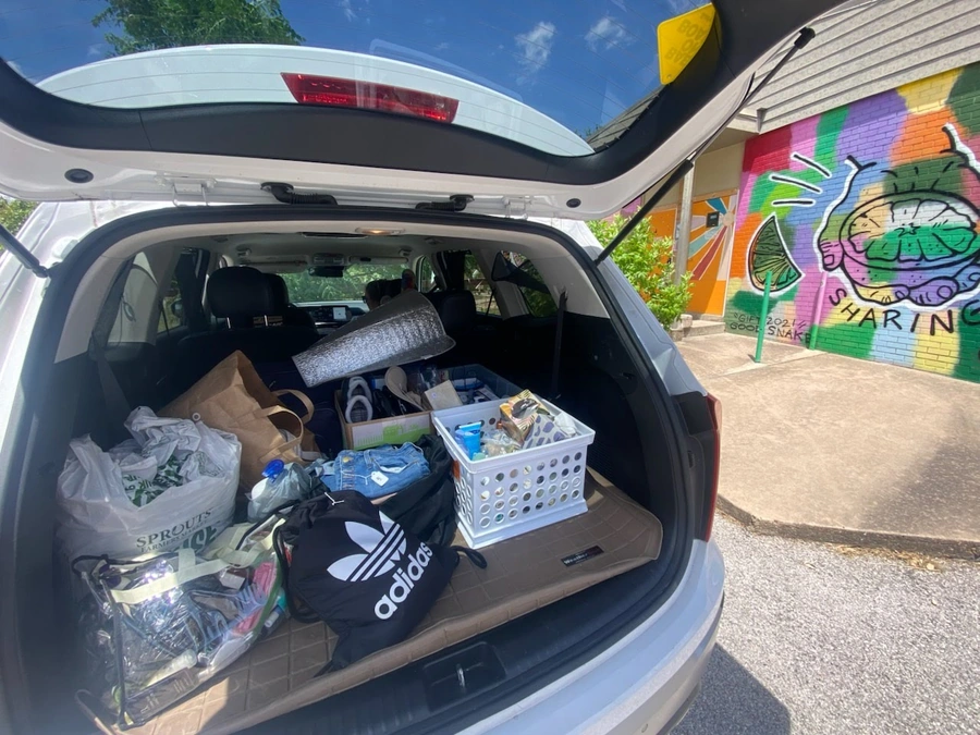 Household items in trunk of car at donation drop off