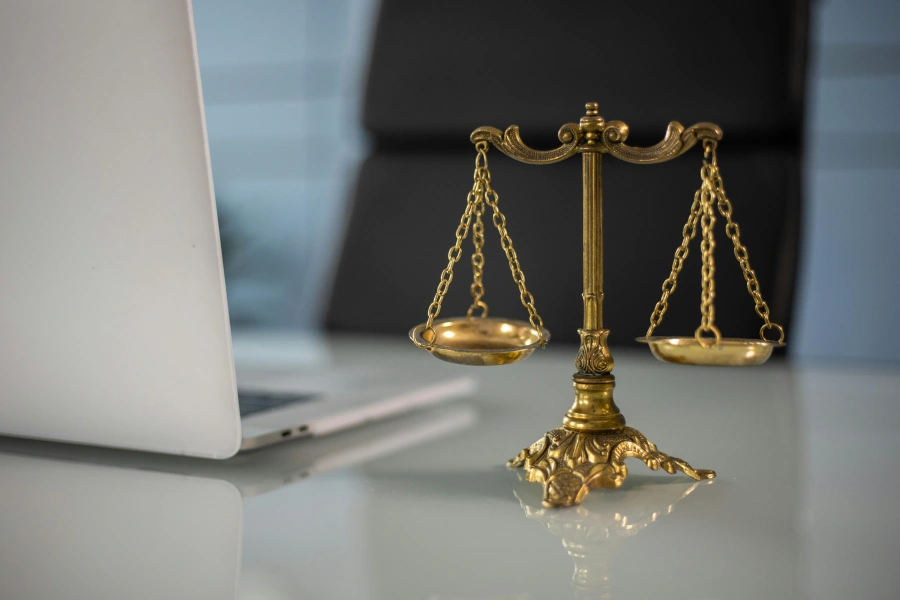 Modern legal workspace with computer and scales of justice