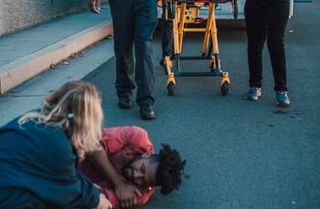 Paramedics bringing a stretcher to someone that's been severely injured