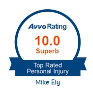 A blue circular badge with orange and white text that reads "Avvo Rating 10.0 Superb - Top Rated Personal Injury - Mike Ely".