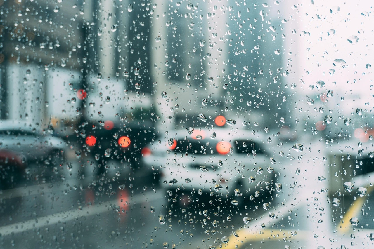 Traffic stopped through a rainy window