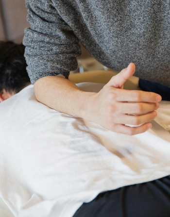 Man giving deep tissue massage to client