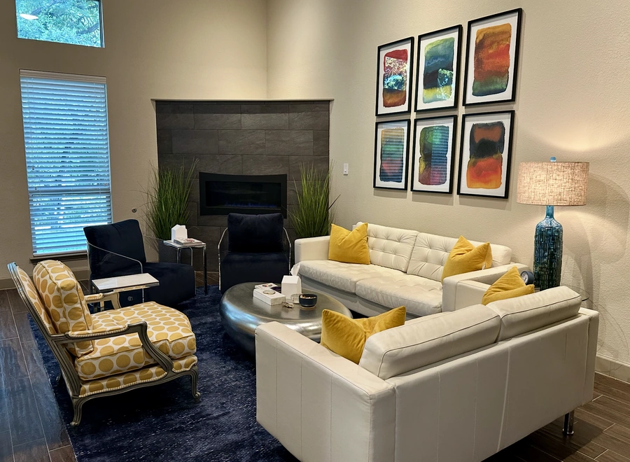 Katey Villalon's cozy therapy office with couches, chairs and a fire place