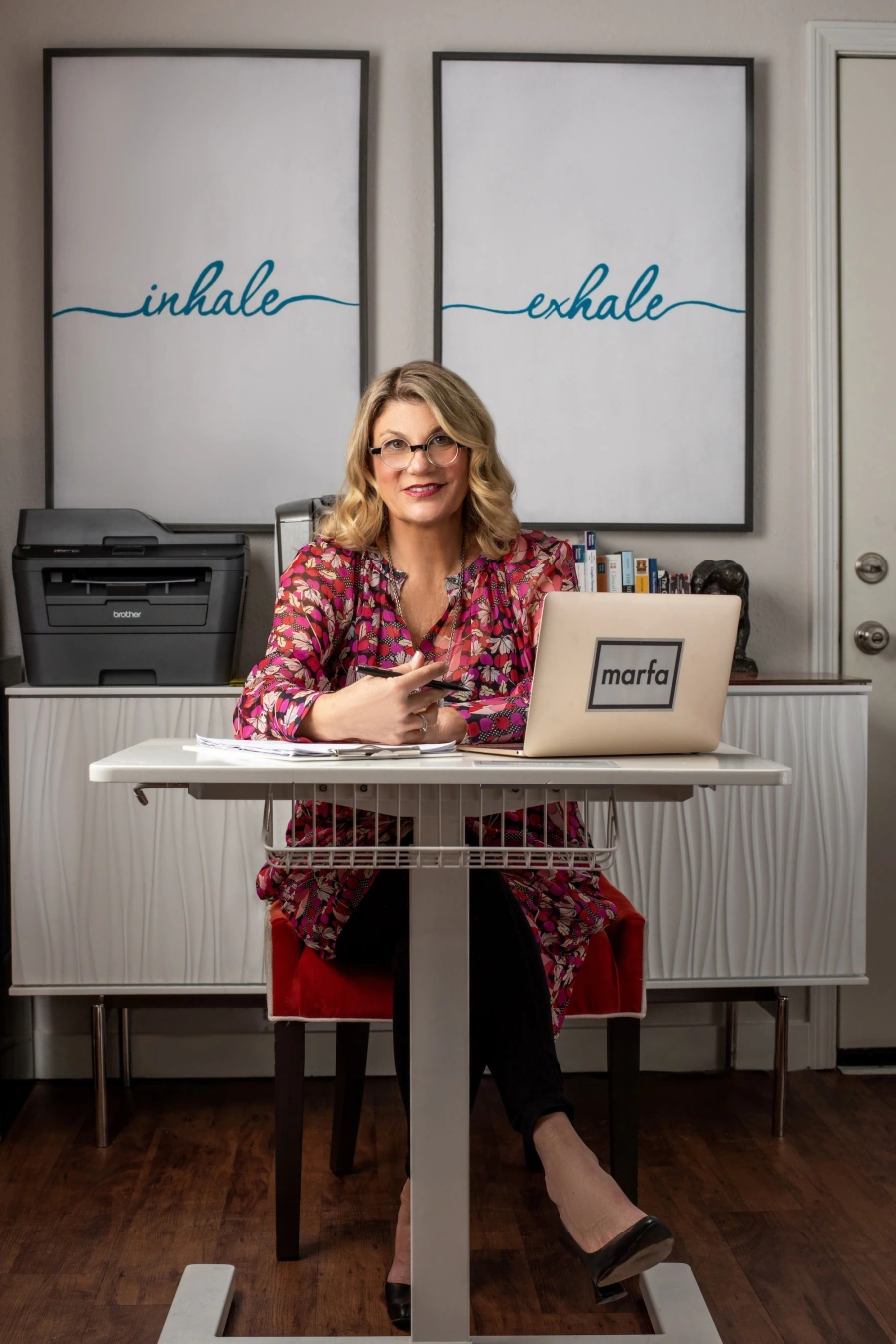 Woman at home desk engaging in video therapy session