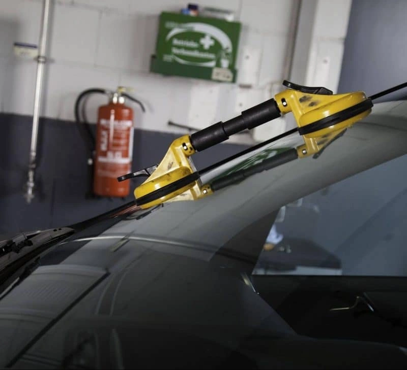 An image of car windshield wipers on a vehicle, indicating the services offered by Magic Auto Glass.