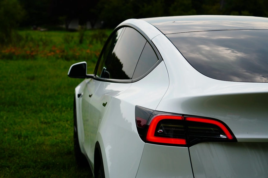Photo of tesla from back and side of the car