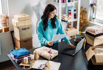 Small business owner reviewing compliance paperwork