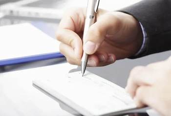 Business professional signing legal document