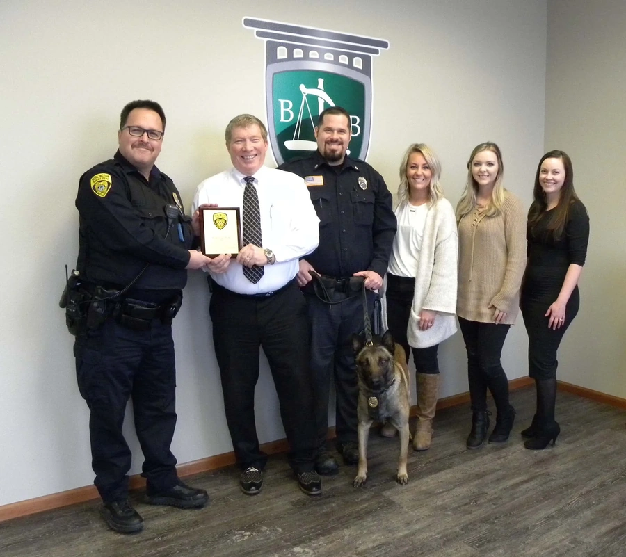 Police officers attending a community event, shown standing together in uniform.