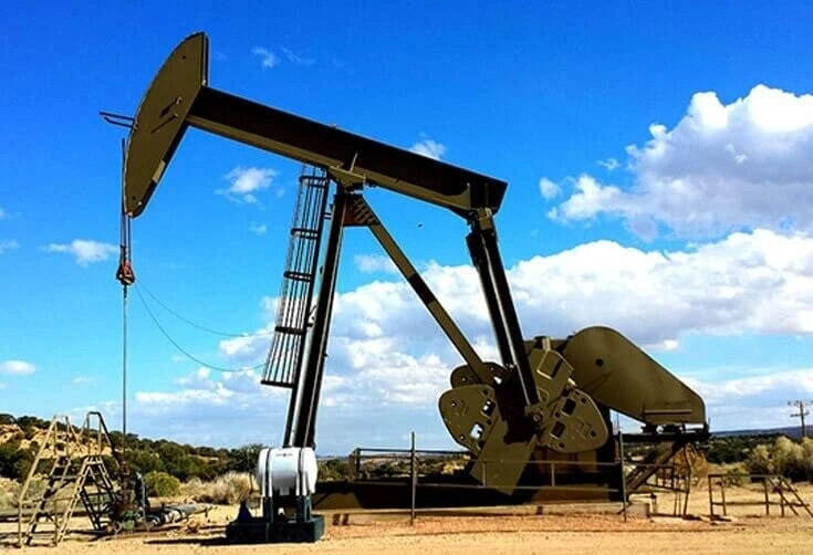 Oil pumpjack on a dry site beneath blue sky, illustrating mineral and oil operations