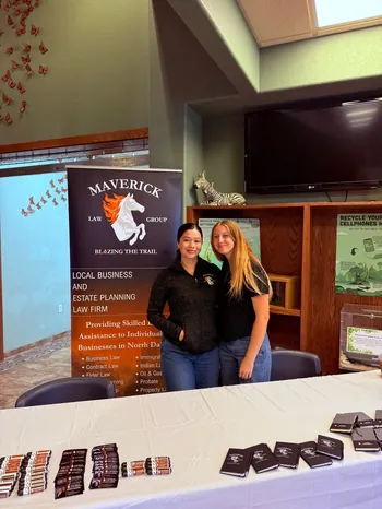 Maverick Law Group team members at a community event booth