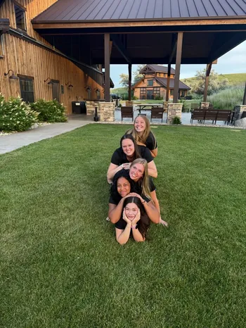 Maverick team members posing together on the lawn