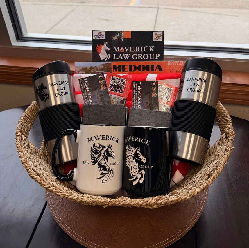 Maverick Law Group gift basket with branded mugs and Medora tickets