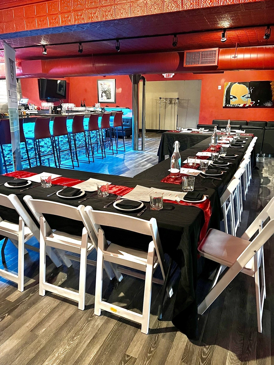 Attendees socializing with drinks at a community Wills & Wine event