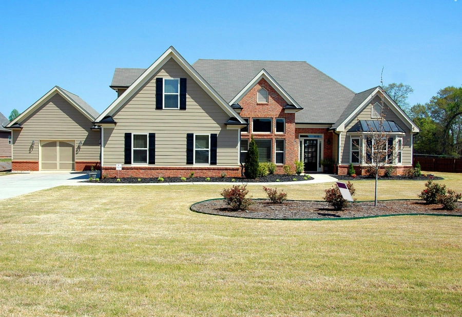Professionally landscaped front yard with manicured lawn