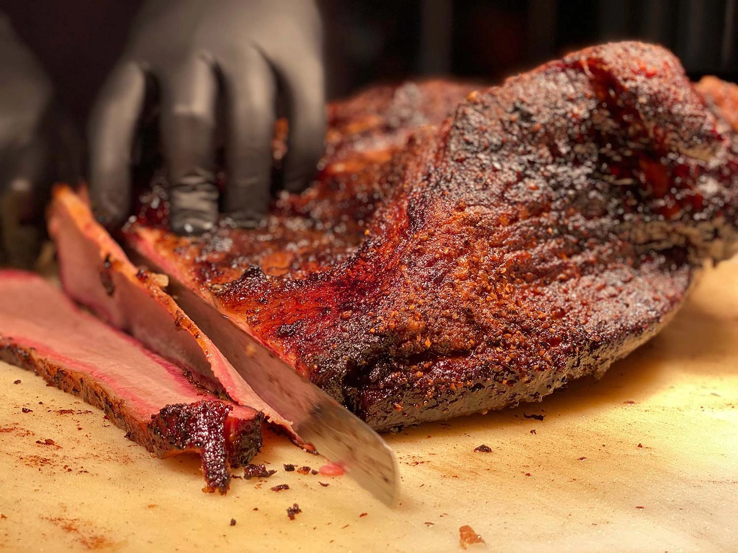 Brisket being cut by a pit master