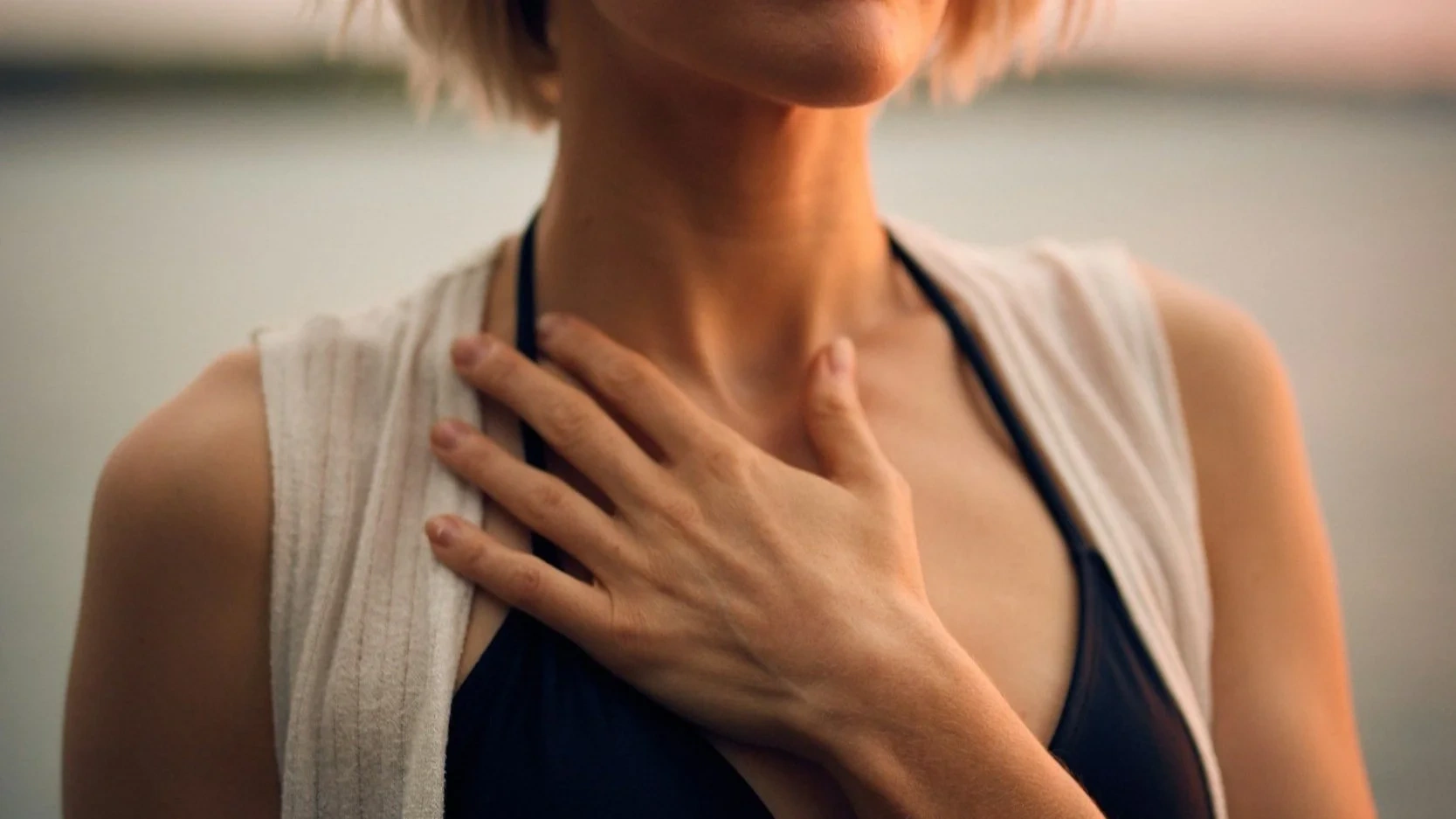 Woman holding hand over her heart