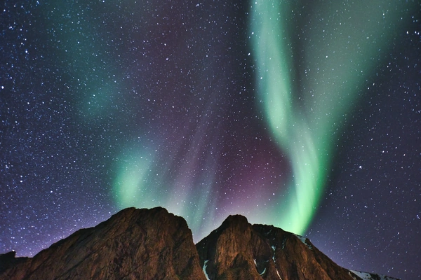 The aurora borealis over mountain tops