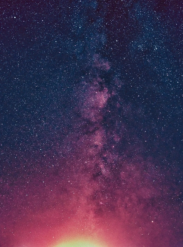 Galaxy with stars and edge of sun shining into the photo
