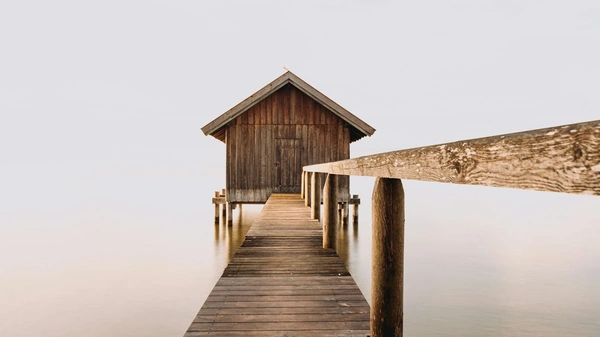 Boardwalk path over water to wooden house