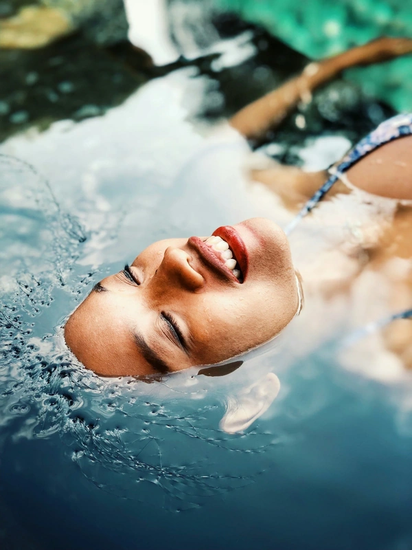 Woman peacefully floating in clear water
