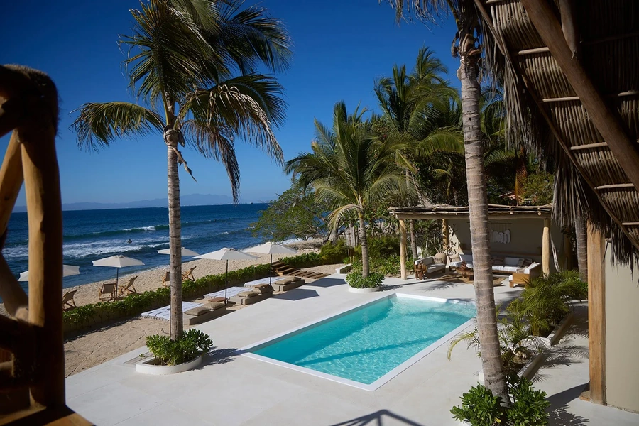 Pool surrounded by palm trees on beach