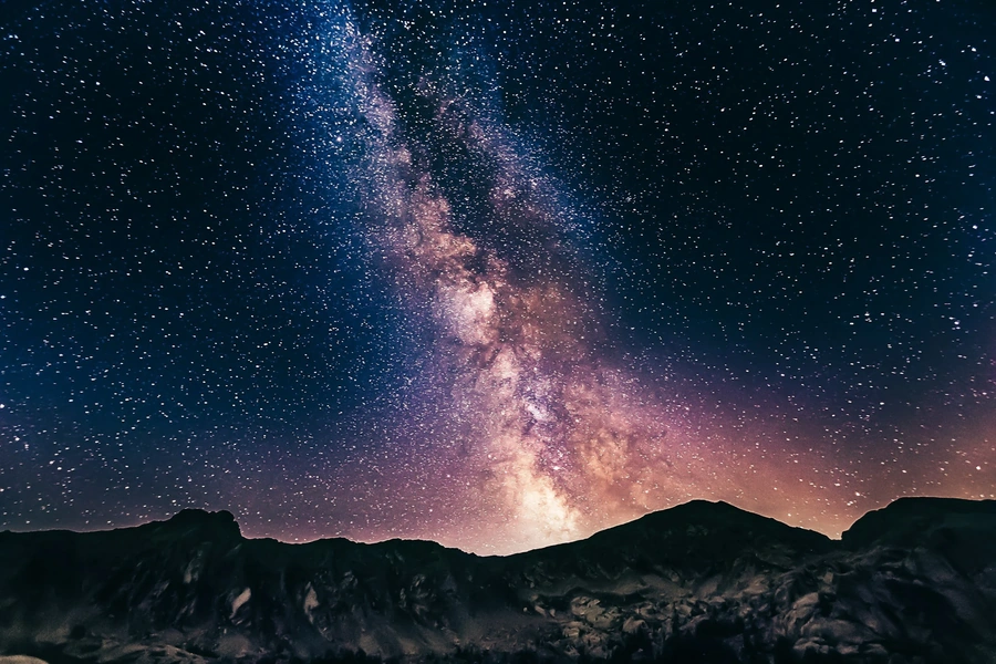Galaxy of milky way and stars over mountains at night