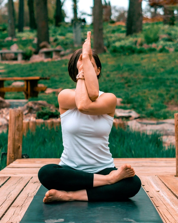 Woman doing yoga on deck