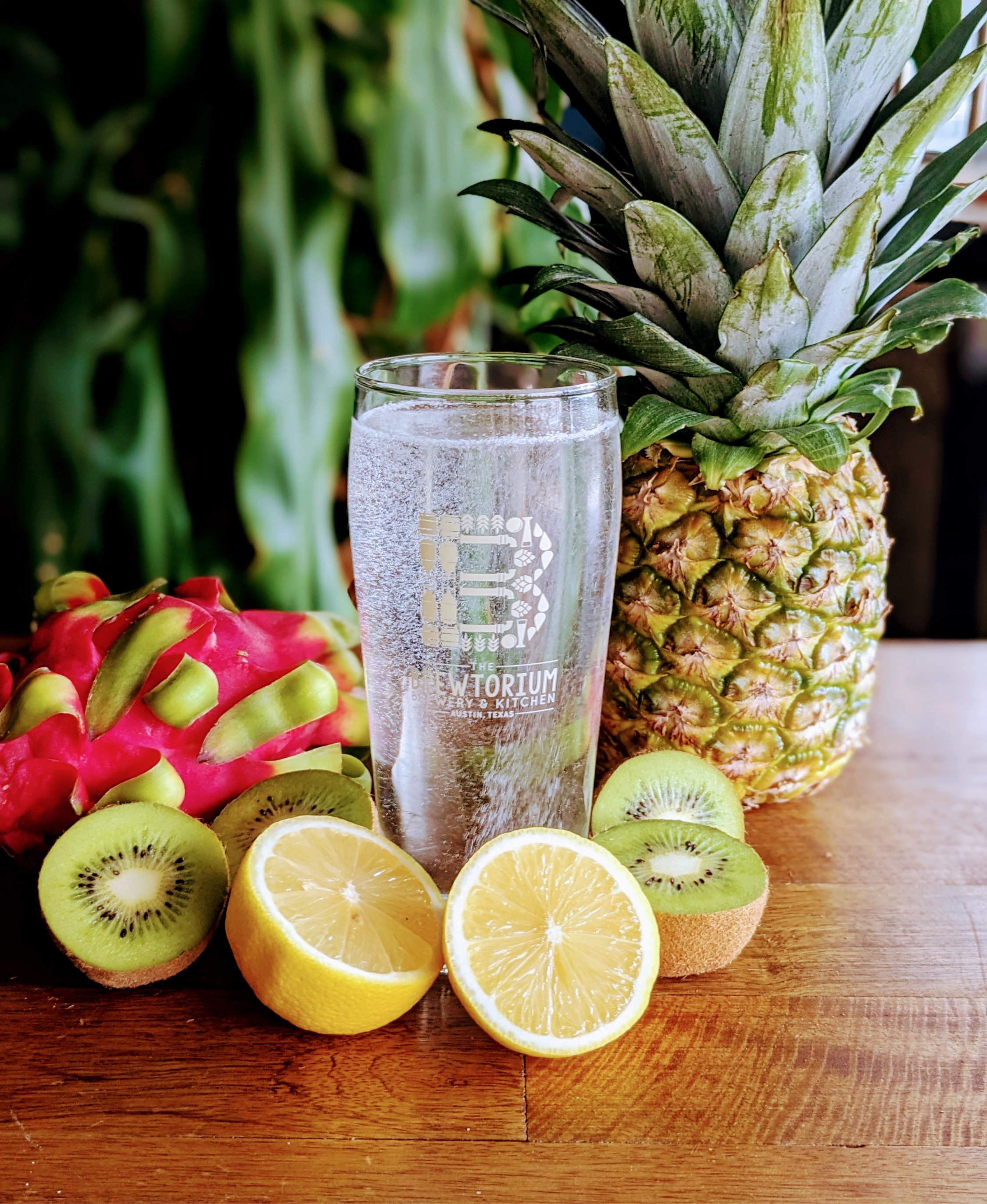 Sparkling lemon, kiwi, and pineapple beverage in a Brewtorium glass