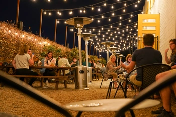 Outdoor patio at night with lights at The Brewtorium