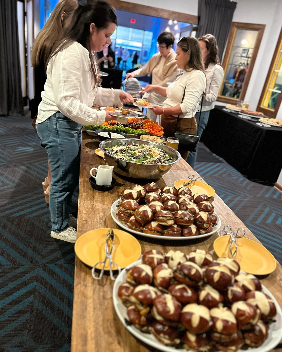 Gourmet catering spread at Brewtorium featuring an array of artisanal sandwiches, fresh salads, and elegant presentation for private events and parties