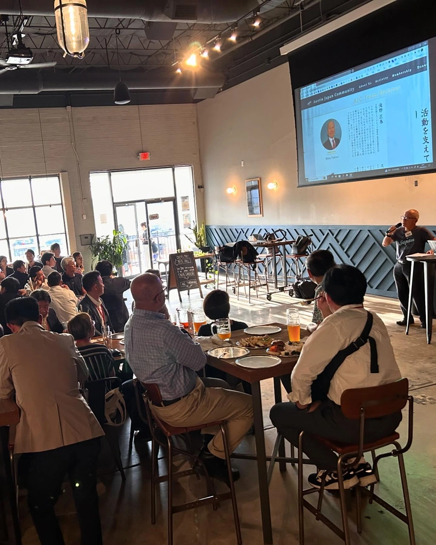 Brewtorium's spacious venue hosting a large group event, with long tables, festive decorations, and a lively crowd enjoying food and drinks
