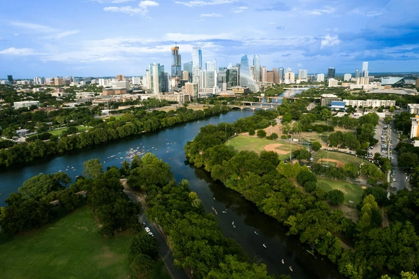 Experience Austin's vibrant skyline and scenic Colorado River from above, capturing the essence of a summer day.