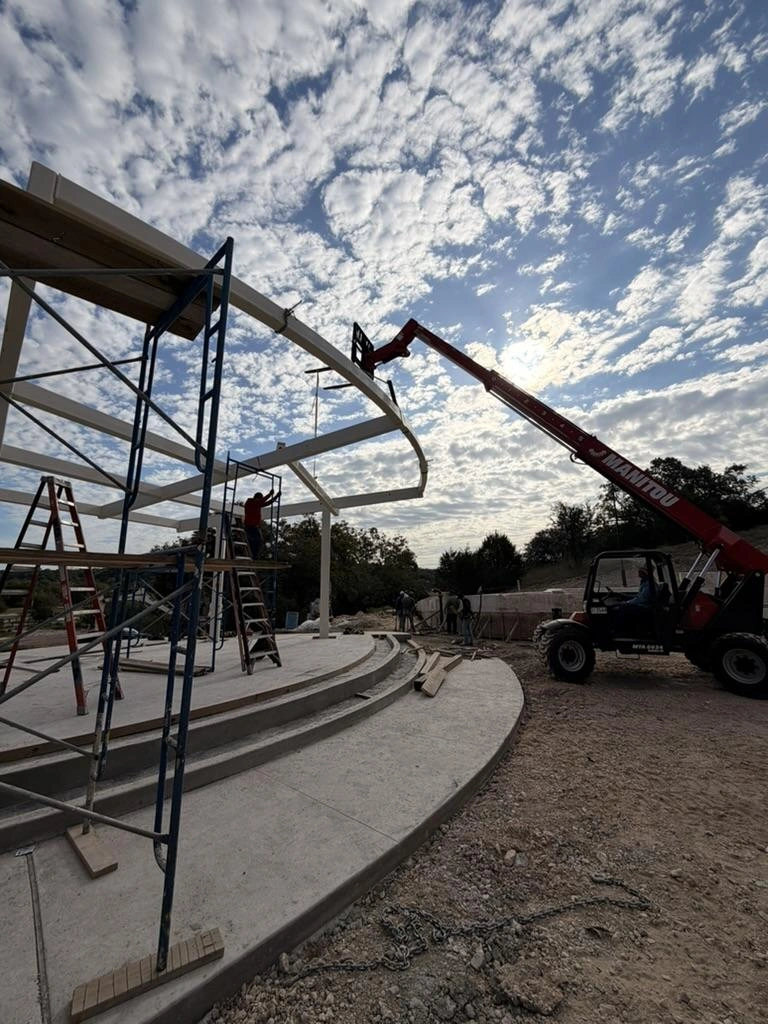 Crew on scaffolding setting curved canopy steel at Garey Park