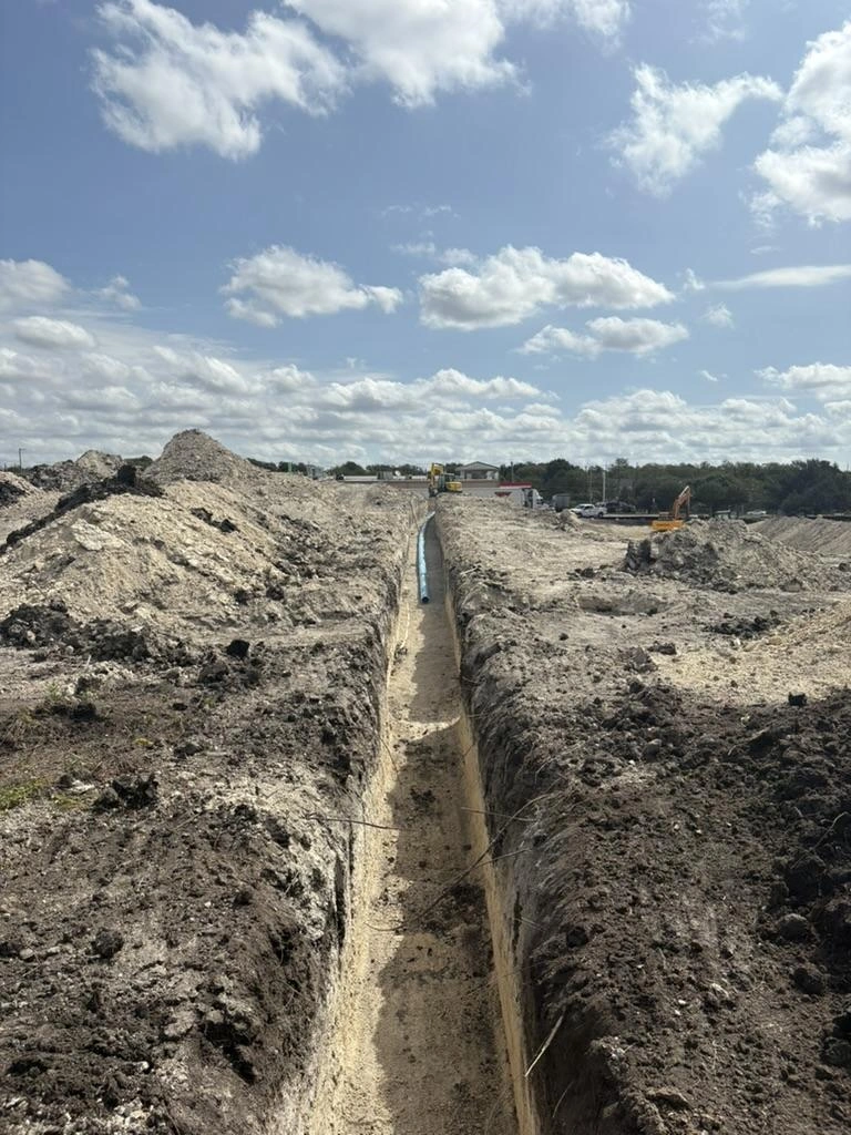 Long open utility trench across the Pflugerville Marketplace site