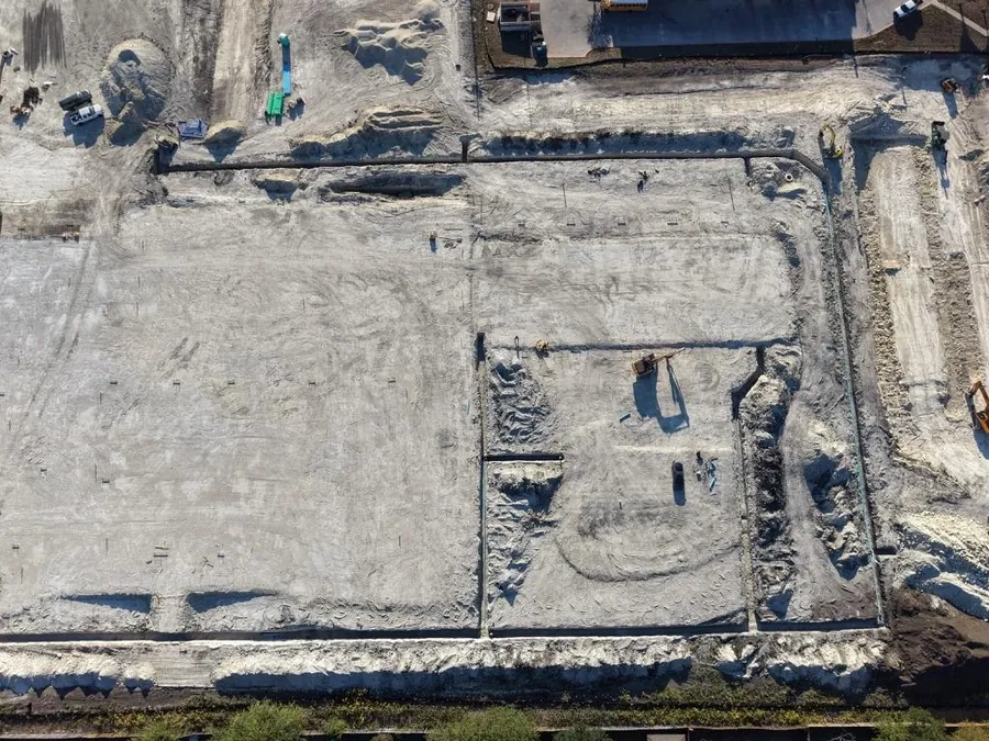 Overhead drone view of the Pflugerville Marketplace building pad and utility trenches