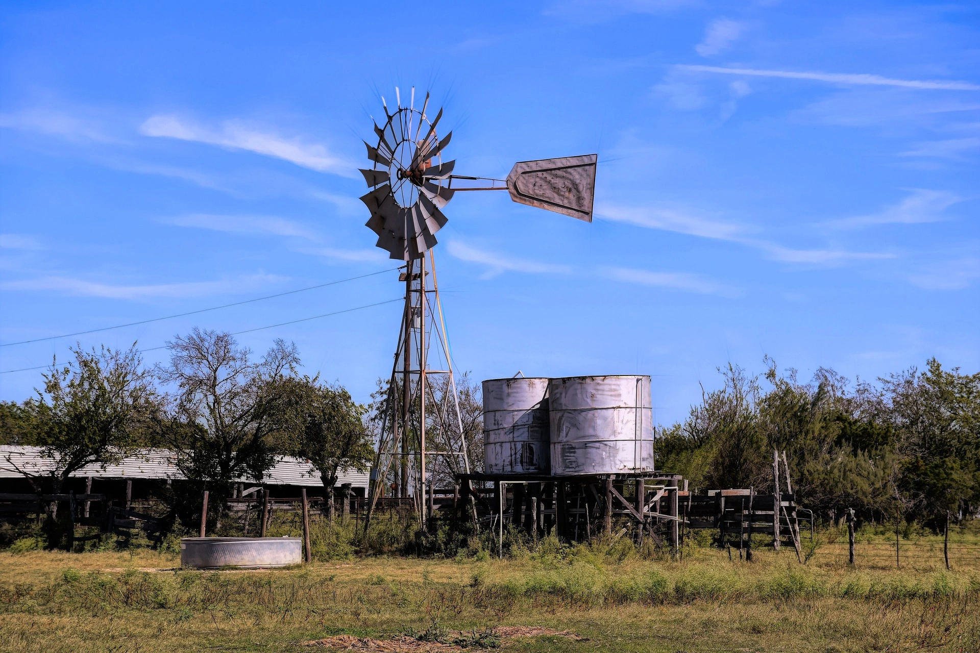Windmill and water tanks on clear day on a Texas Ranch