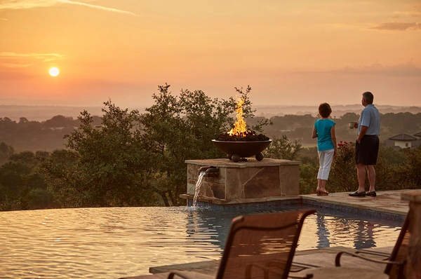 Couple enjoying a sunset view from their pool at Cordillera Ranch