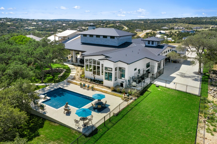 Aerial view of back exterior and pool of Vintage Luxury Builders custom build home