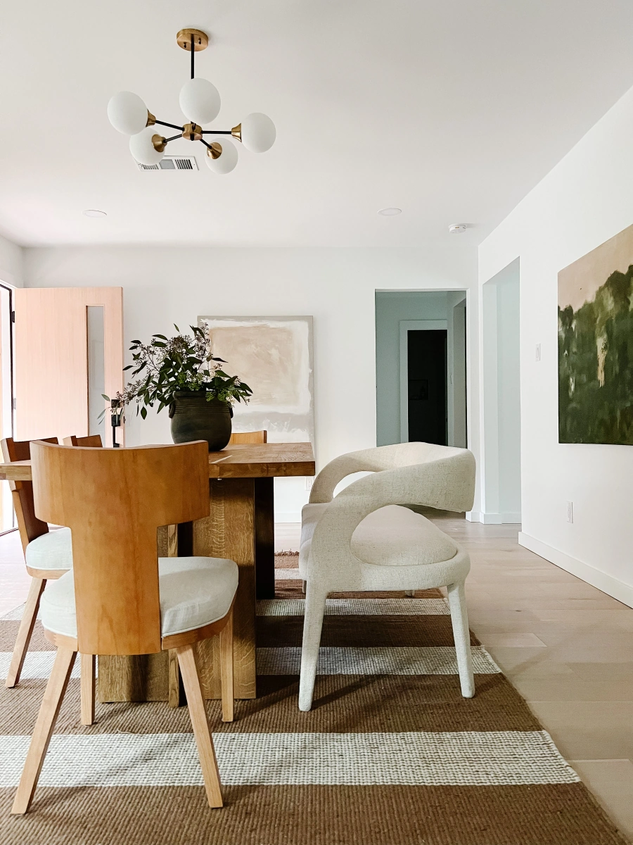 Modern dining room with modern chandelier and wooden furniture