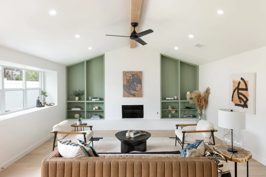 Living room with vaulted ceiling and sage green built-ins
