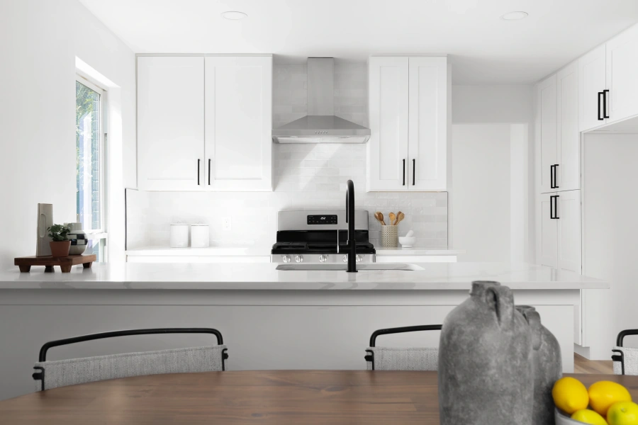 Modern white kitchen with black counter stools