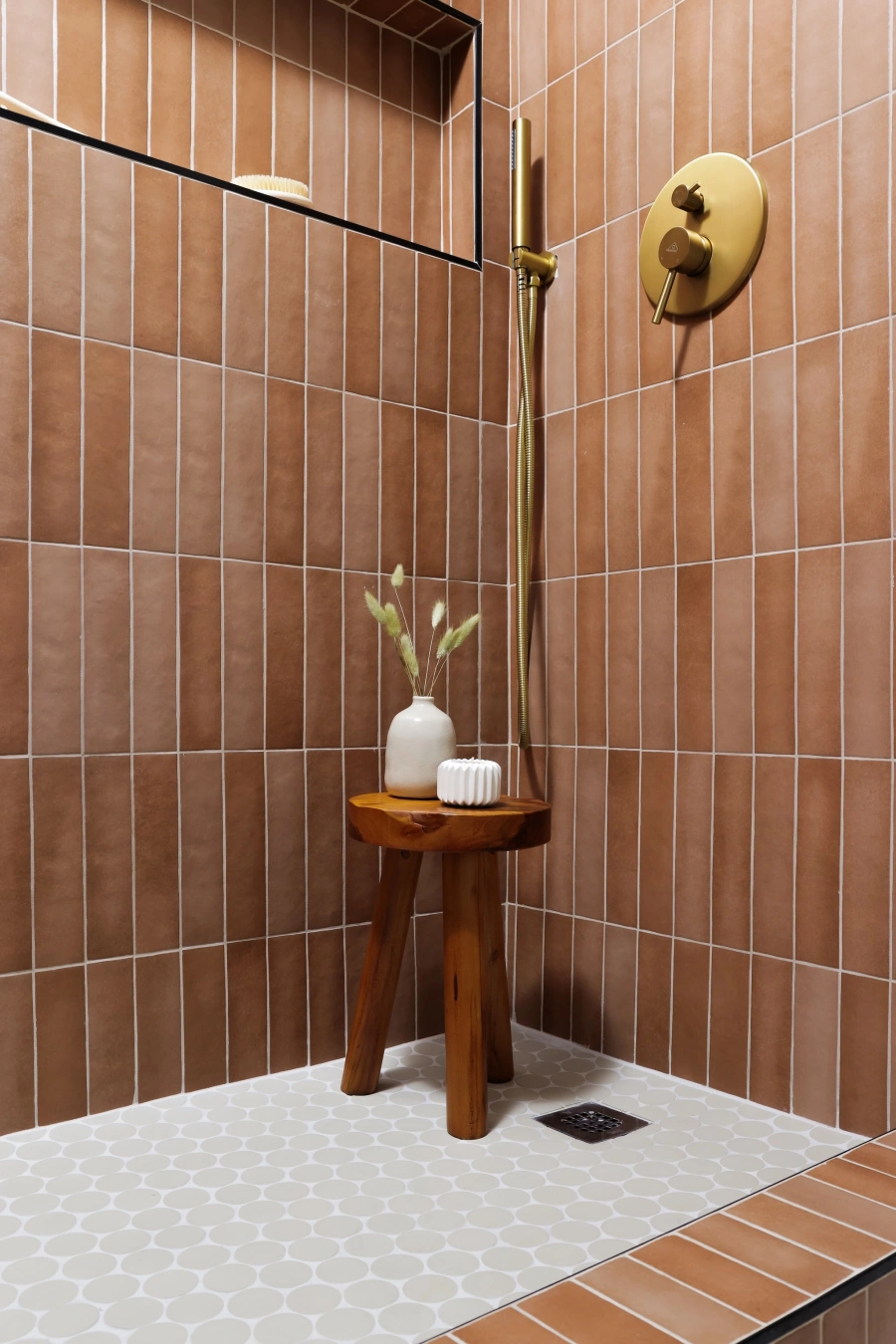 Bathroom with terracotta tile and brass fixtures